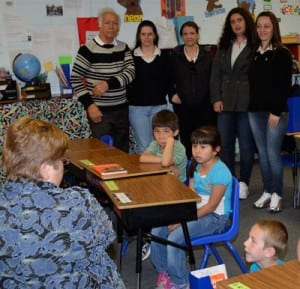 A Group Study Exchange team from Brazil observes youngsters as they practice reading skills with Teacher Terri Meyer during reading class Tuesday. (Republican photo)