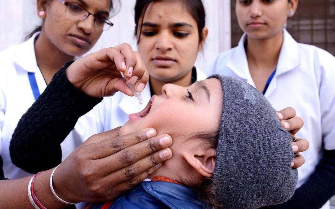 An Indian child receives polio vaccination drops