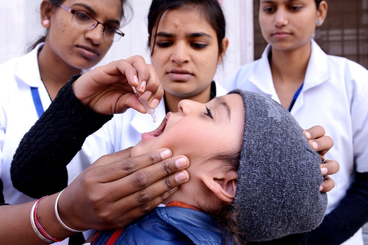 An Indian child receives polio vaccination drops